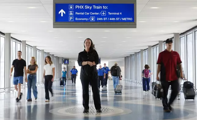 Lindsay Ruck, a server at Phoenix Sky Harbor International Airport restaurants, pauses in Terminal 3 as she is anticipates the vote on Arizona Prop 138 on minimum wage Thursday, Oct. 3, 2024, in Phoenix. (AP Photo/Ross D. Franklin)