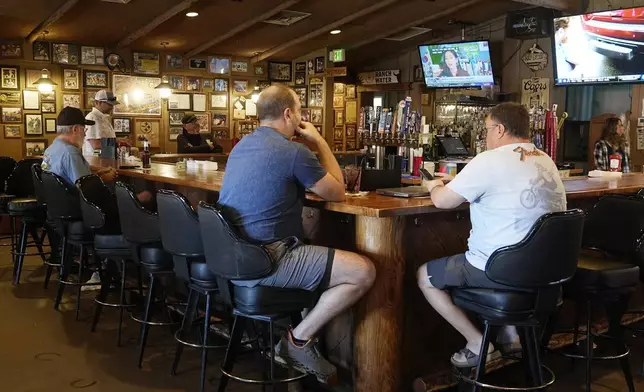 Patrons sit at the bar for lunch at Harold's Cave Creek Corral, regarding Arizona Prop 138 on minimum wage Thursday, Oct. 3, 2024, in Cave Creek, Ariz. (AP Photo/Ross D. Franklin)