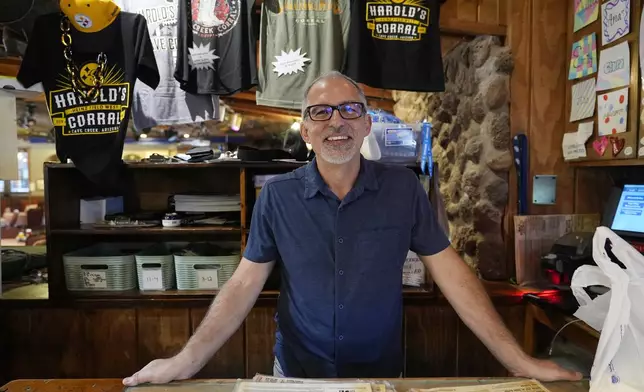 Dan Piacquadio, owner of Harold's Cave Creek Corral, stands at the front register as he is awaiting the results regarding Arizona Prop 138 on minimum wage Thursday, Oct. 3, 2024, in Cave Creek, Ariz. (AP Photo/Ross D. Franklin)