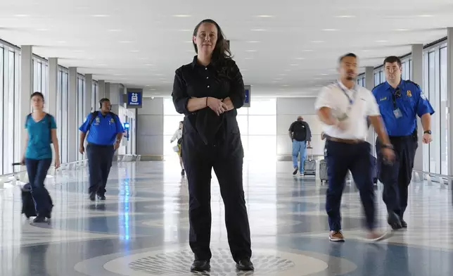 Lindsay Ruck, a server at Phoenix Sky Harbor International Airport restaurants, pauses in Terminal 3 as she works for minimum wage plus tips and is interested in the upcoming election and the Arizona Prop 138 on minimum wage vote Thursday, Oct. 3, 2024, in Phoenix. (AP Photo/Ross D. Franklin)