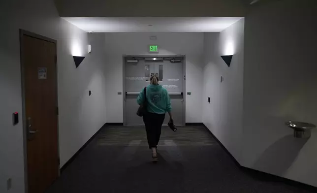 Cari-Ann Burgess, interim Registrar of Voters for Washoe County, Nev., leaves the office after working Saturday, Sept. 21, 2024, in Reno, Nev. (AP Photo/John Locher)