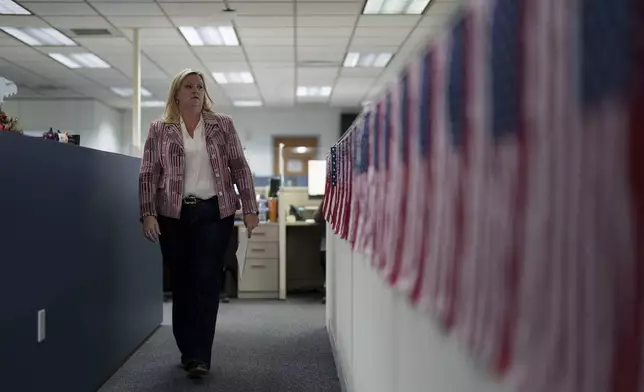 Cari-Ann Burgess, interim Registrar of Voters for Washoe County, Nev., walks through the office Friday, Sept. 20, 2024, in Reno, Nev. (AP Photo/John Locher)