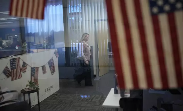 Cari-Ann Burgess, interim Registrar of Voters for Washoe County, Nev., walks through the office, Friday, Sept. 20, 2024, in Reno, Nev. (AP Photo/John Locher)