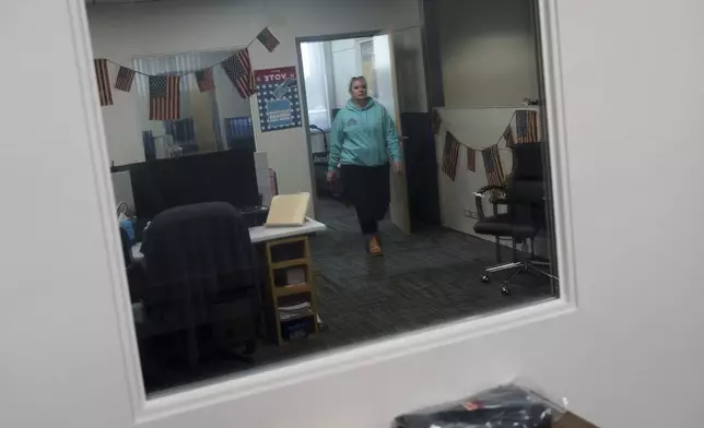 Cari-Ann Burgess, interim Registrar of Voters for Washoe County, Nev., walks through the office Saturday, Sept. 21, 2024, in Reno, Nev. (AP Photo/John Locher)