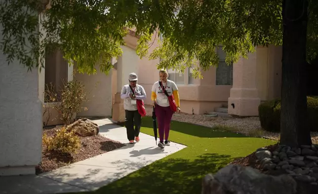 Florisela Lopez Rivera, left, canvasses with fellow Culinary Workers Union member Suldenil Alvarez, Tuesday, Sept. 10, 2024, in Las Vegas. Originally from El Salvador, Lopez Rivera recently gained permanent U.S. residency after her wife became a citizen. (AP Photo/John Locher)