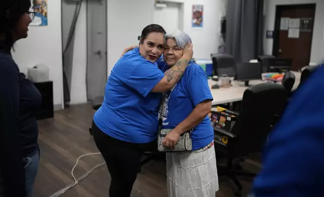 Erika Marquez, left, embraces Leticia Pinedo after a meeting at the nonprofit Make the Road Nevada, Thursday, Sept. 12, 2024, in Las Vegas. Marquez is a recipient of an Obama administration amnesty for immigrants brought to the U.S. illegally as children. (AP Photo/John Locher)