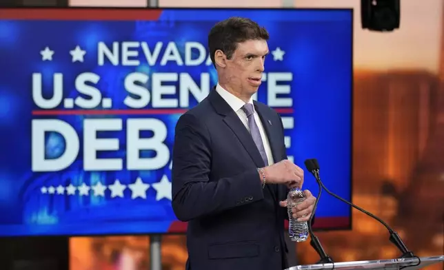 Republican senatorial candidate Sam Brown prepares before a debate with Sen. Jacky Rosen, D-Nev., Thursday, Oct. 17, 2024, in Las Vegas. (AP Photo/John Locher)