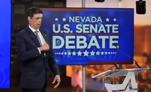 Republican senatorial candidate Sam Brown prepares before a debate with Sen. Jacky Rosen, D-Nev., Thursday, Oct. 17, 2024, in Las Vegas. (AP Photo/John Locher)