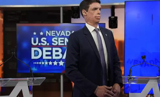 Republican senatorial candidate Sam Brown stands in a tv studio before a debate with Sen. Jacky Rosen, D-Nev., Thursday, Oct. 17, 2024, in Las Vegas. (AP Photo/John Locher)