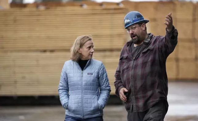 Joyce Craig, Democratic candidate for governor, talks with sawmill manager Joey St. Onge during a visit to the Milan Lumber mill, Wednesday, Oct. 16, 2024, in Milan, N.H. (AP Photo/Robert F. Bukaty)