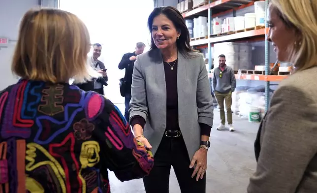 Republican gubernatorial candidate Kelly Ayotte, who faces Democrat Joyce Craig in the November 2024 election, shakes hands with administrators during a visit to a local concrete coating business, Wednesday, Oct. 16, 2024, in Manchester, N.H. (AP Photo/Charles Krupa)