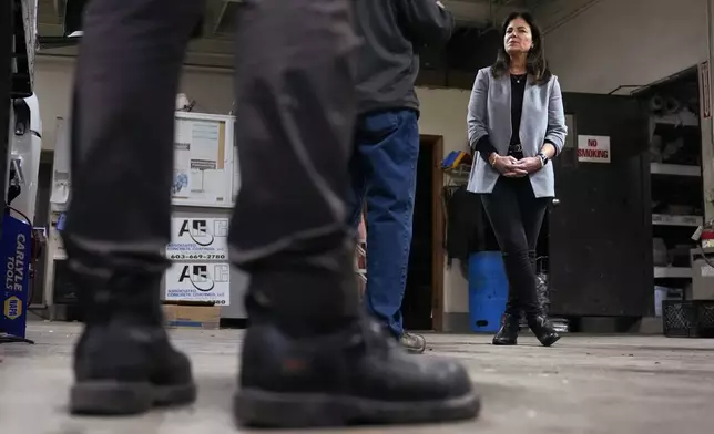 Republican gubernatorial candidate Kelly Ayotte, who faces Democrat Joyce Craig in the November 2024 election, listens to employees during a visit to a local concrete coating business, Wednesday, Oct. 16, 2024, in Manchester, N.H. (AP Photo/Charles Krupa)