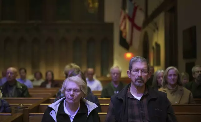 Pat, left, and Joe Weaver sit in meditation during a weekly "Contemplative Citizenship" service at St. James Episcopal Church in Lancaster, Pa., on Tuesday, Oct. 15, 2024. (AP Photo/Jessie Wardarski)