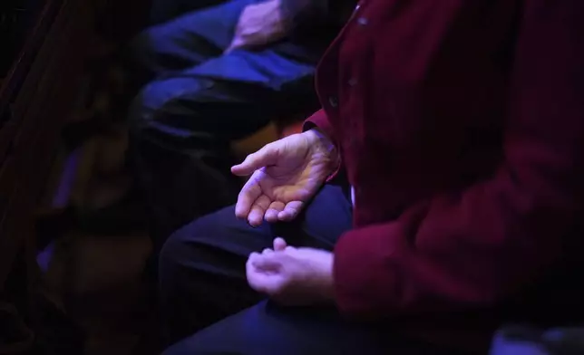 Lissa Olson places her hands on her lap during a meditation centered around the Jesus Prayer, an Orthodox Christian prayer, at St. James Episcopal Church in Lancaster, Pa., on Tuesday, Oct. 15, 2024. (AP Photo/Jessie Wardarski)