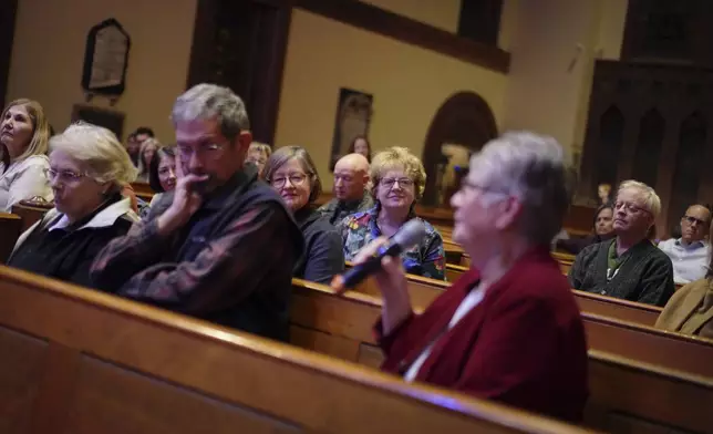 Attendees share their thoughts and reflections at the end of a "Contemplative Citizenship" service at St. James Episcopal Church in Lancaster, Pa., on Tuesday, Oct. 15, 2024. (AP Photo/Jessie Wardarski)