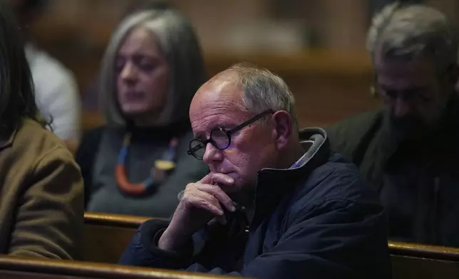 Dennis Downey, center, sits in meditation at St. James Episcopal Church's weekly "Contemplative Citizenship" service in Lancaster, Pa., on Tuesday, Oct. 15, 2024. (AP Photo/Jessie Wardarski)