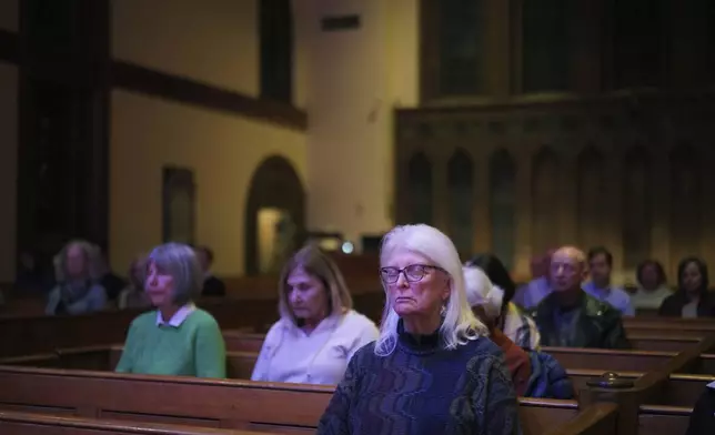 People sit in meditation during a "Contemplative Citizenship" service at St. James Episcopal Church in Lancaster, Pa., on Tuesday, Oct. 15, 2024. (AP Photo/Jessie Wardarski)