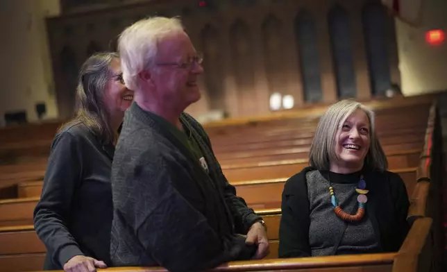 Susan Bickel, left, David Bickel, and Connie Hazeltine share a laugh after a "Contemplative Citizenship" service at St. James Episcopal Church in Lancaster, Pa., on Tuesday, Oct. 15, 2024. (AP Photo/Jessie Wardarski)