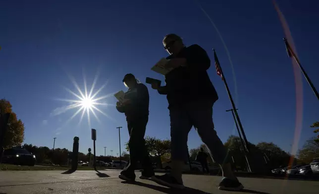 Voters return their mail-in ballots for the 2024 General Election in the United States outside the Chester County Government Services Center, Friday, Oct. 25, 2024, in West Chester, Pa. (AP Photo/Matt Slocum)