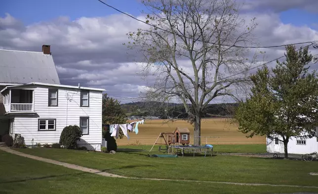 Clothes blow in the wind outside of a home in Ephrata, Pa., on Wednesday, Oct. 16, 2024. (AP Photo/Jessie Wardarski)