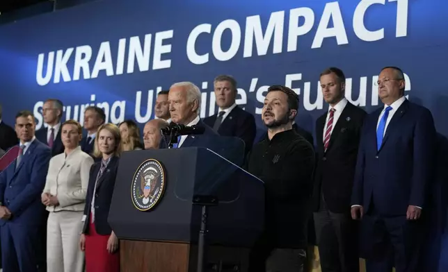 FILE - President Joe Biden, center left, and Ukrainian President Volodymyr Zelenskyy, center right, speak at an event with NATO leaders on the sidelines of the NATO Summit in Washington on July 11, 2024. (AP Photo/Susan Walsh, File)