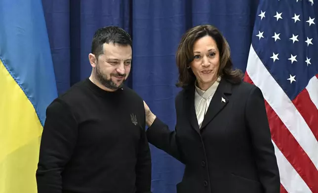 FILE - Ukrainian President Volodymyr Zelenskyy, left, and U.S. Vice President Kamala Harris pose for pictures at the end of a news conference at the Munich Security Conference in Munich, Germany, on Feb. 17, 2024. (Tobias Schwarz/Pool via AP, File)