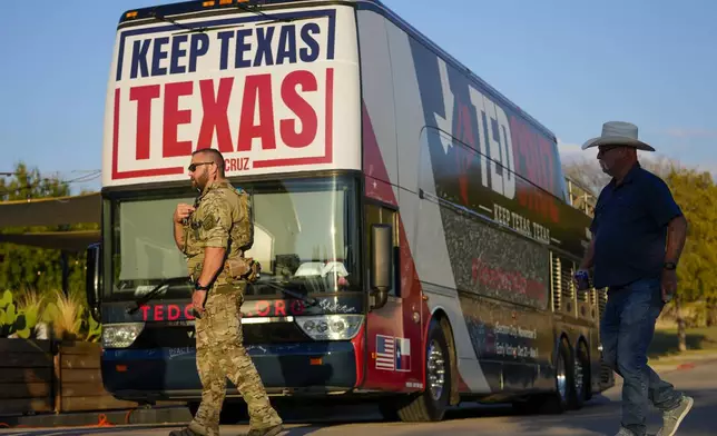 A security official stands near a bus during a campaign event for Sen. Ted Cruz, R-Texas, Saturday, Oct. 5, 2024, in Keller, Texas. (AP Photo/Julio Cortez)