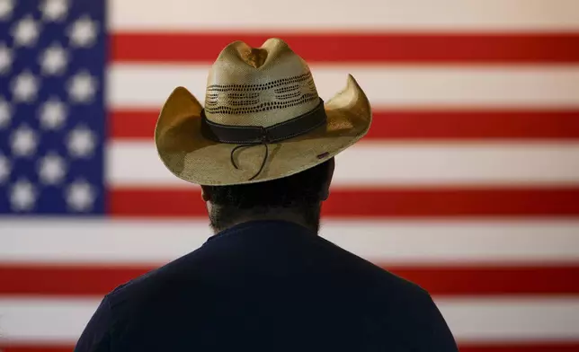 A person waits for the start of a campaign event for Sen. Ted Cruz, R-Texas, Saturday, Oct. 5, 2024, in Keller, Texas. (AP Photo/Julio Cortez)