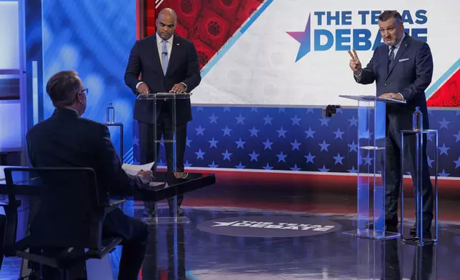 Rep. Colin Allred, D-Texas, top left, takes notes as Sen. Ted Cruz, R-Texas, speaks during a U.S. Senate debate, Tuesday, Oct. 15, 2024, in Dallas. (Shelby Tauber/Texas Tribune via AP, Pool)