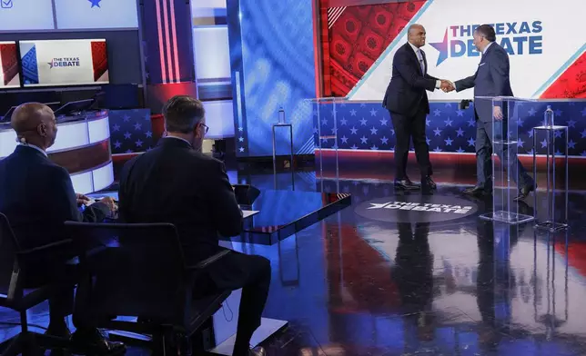 Rep. Colin Allred, D-Texas, top left, and Sen. Ted Cruz, R-Texas, greet each other at the beginning of a U.S. Senate debate, Tuesday, Oct. 15, 2024, in Dallas. (Shelby Tauber/Texas Tribune via AP, Pool)