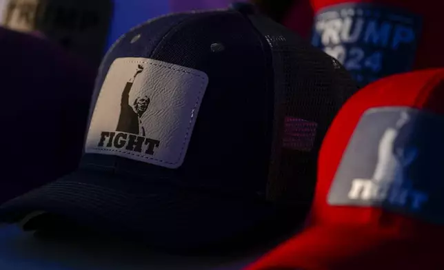 Hats with the likeness of Republican presidential nominee former President Donald Trump are seen at a campaign event for Sen. Ted Cruz, R-Texas, Saturday, Oct. 5, 2024, in Keller, Texas. AP Photo/Julio Cortez)