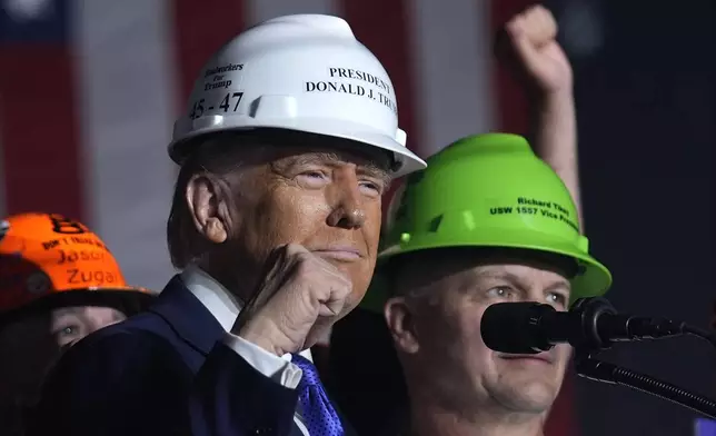 Republican presidential nominee former President Donald Trump stands on stage with steelworkers as he speaks at a campaign rally, Saturday, Oct. 19, 2024, at Arnold Palmer Regional Airport in Latrobe, Pa. (AP Photo/Evan Vucci)