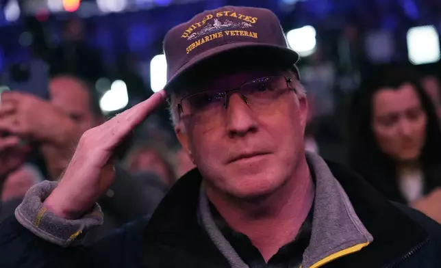 An attendee salutes at a campaign rally for Republican presidential nominee former President Donald Trump at Madison Square Garden, Sunday, Oct. 27, 2024, in New York. (AP Photo/Julia Demaree Nikhinson)