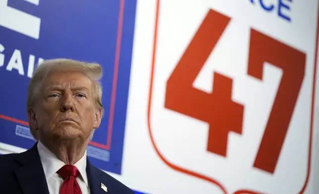 Republican presidential nominee former President Donald Trump listens as he visits a campaign office, Friday, Oct. 18, 2024, in Hamtramck, Mich. (AP Photo/Evan Vucci)