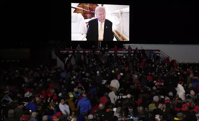 A video message from Republican presidential nominee former President Donald Trump is played at a campaign event Friday, Oct. 25, 2024, in Traverse City, Mich. (AP Photo/Paul Sancya)