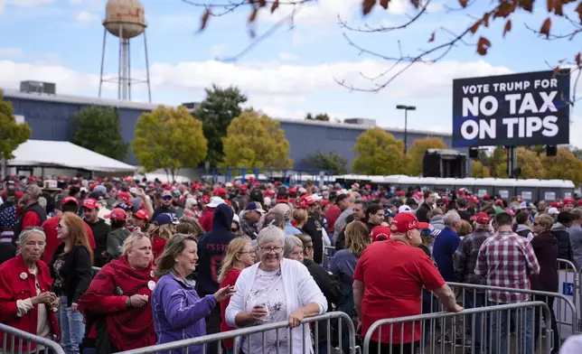 People wait in line to attend a Republican presidential nominee former President Donald Trump campaign town hall, Monday, Oct. 14, 2024, in Oaks, Pa. (AP Photo/Matt Rourke)