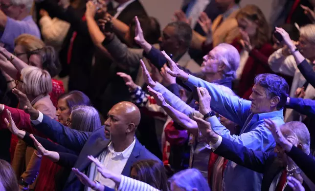 Supporters pray for Republican presidential nominee former President Donald Trump after the National Faith Summit at Worship With Wonders Church, Monday, Oct. 28, 2024, in Powder Springs, Ga. (AP Photo/Brynn Anderson)