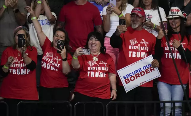 Supporters react before Republican presidential nominee former President Donald Trump speaks at a campaign rally at the Findlay Toyota Arena Sunday, Oct. 13, 2024, in Prescott Valley, Ariz. (AP Photo/Ross D. Franklin)