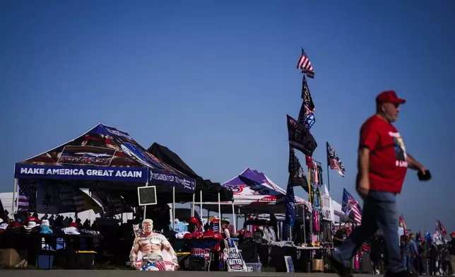 Vendors sell merchandise ahead of Republican presidential nominee former President Donald Trump's campaign rally, Saturday, Oct. 19, 2024, at Arnold Palmer Regional Airport in Latrobe, Pa. (AP Photo/Matt Rourke)