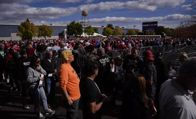 People wait in line to attend a Republican presidential nominee former President Donald Trump campaign town hall, Monday, Oct. 14, 2024, in Oaks, Pa. (AP Photo/Matt Rourke)