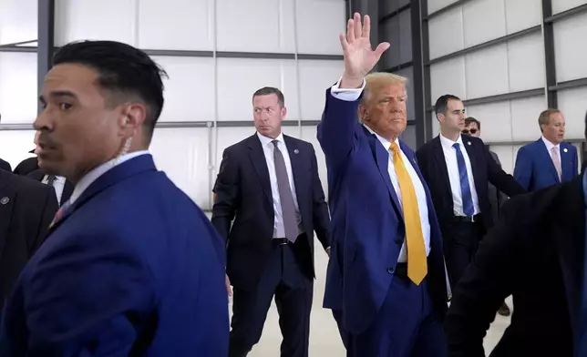 Republican presidential nominee former President Donald Trump waves as he departs a news conference at Austin-Bergstrom International Airport, Friday, Oct. 25, 2024, in Austin, Texas. (AP Photo/Alex Brandon)