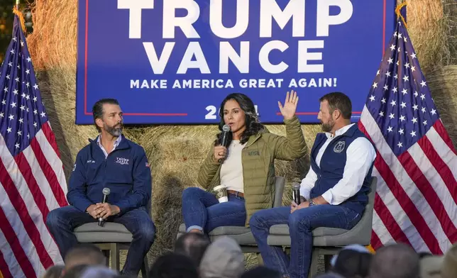 Donald Trump Jr., former Democratic Rep. Tulsi Gabbard and Sen. Markwayne Mullin, R-Okla, speak during a campaign event in support of Republican presidential candidate former President Donald Trump, Friday, Oct. 18, 2024, in Red Springs, N.C. (AP Photo/David Yeazell)