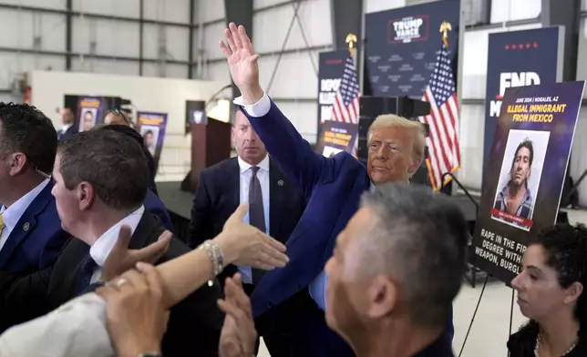 Republican presidential nominee former President Donald Trump waves as he greets attendees upon departs a news conference at Austin-Bergstrom International Airport, Friday, Oct. 25, 2024, in Austin, Texas. (AP Photo/Alex Brandon)