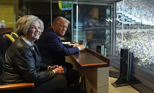 Republican presidential nominee former President Donald Trump sits with Susie Wiles as he attends the New York Jets football game against the Pittsburgh Steelers at Acrisure Stadium, Sunday, Oct. 20, 2024, in Pittsburgh. (AP Photo/Evan Vucci, Pool)