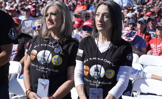 Kelly Comperatore-Meeder, left, and Dawn Comperatore-Schafer, sisters of firefighter Corey Comperatore, who died as he shielded family members from gunfire, attend a campaign event for Republican presidential nominee former President Donald Trump, at the Butler Farm Show, the site where a gunman tried to assassinate Trump in July, Saturday, Oct. 5, 2024, in Butler, Pa. (AP Photo/Alex Brandon)