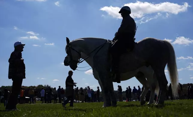 Mounted police watch as supporters arrive before Republican presidential nominee former President Donald Trump speaks at a campaign rally at the Butler Farm Show, Saturday, Oct. 5, 2024, in Butler, Pa. (AP Photo/Julia Demaree Nikhinson)