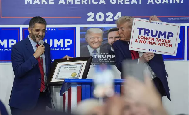 Hamtramck Mayor Amer Ghalib speaks as Republican presidential nominee former President Donald Trump listens at a campaign office, Friday, Oct. 18, 2024, in Hamtramck, Mich. (AP Photo/Evan Vucci)