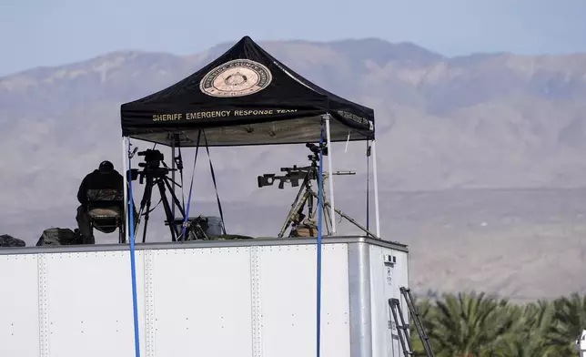 Law enforcement snipers look over the scene before Republican presidential nominee former President Donald Trump speaks at a campaign rally at the Calhoun Ranch, Saturday, Oct. 12, 2024, in Coachella, Calif. (AP Photo/Alex Brandon)