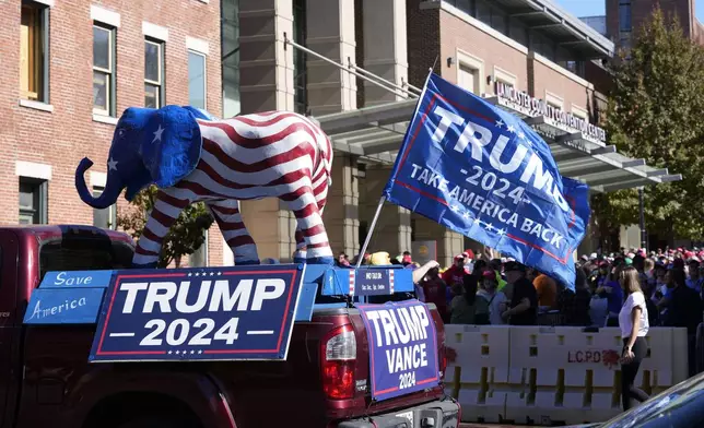 Supporters of Republican presidential nominee former President Donald Trump gather outside the Lancaster Convention Center in Lancaster, Pa., Sunday, Oct. 20, 2024, where Trump will hold a town hall. (AP Photo/Susan Walsh)