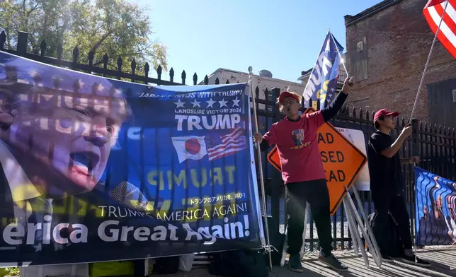 Supporters of Republican presidential nominee former President Donald Trump gather outside the Lancaster Convention Center in Lancaster, Pa., Sunday, Oct. 20, 2024, where Trump will hold a town hall. (AP Photo/Susan Walsh)